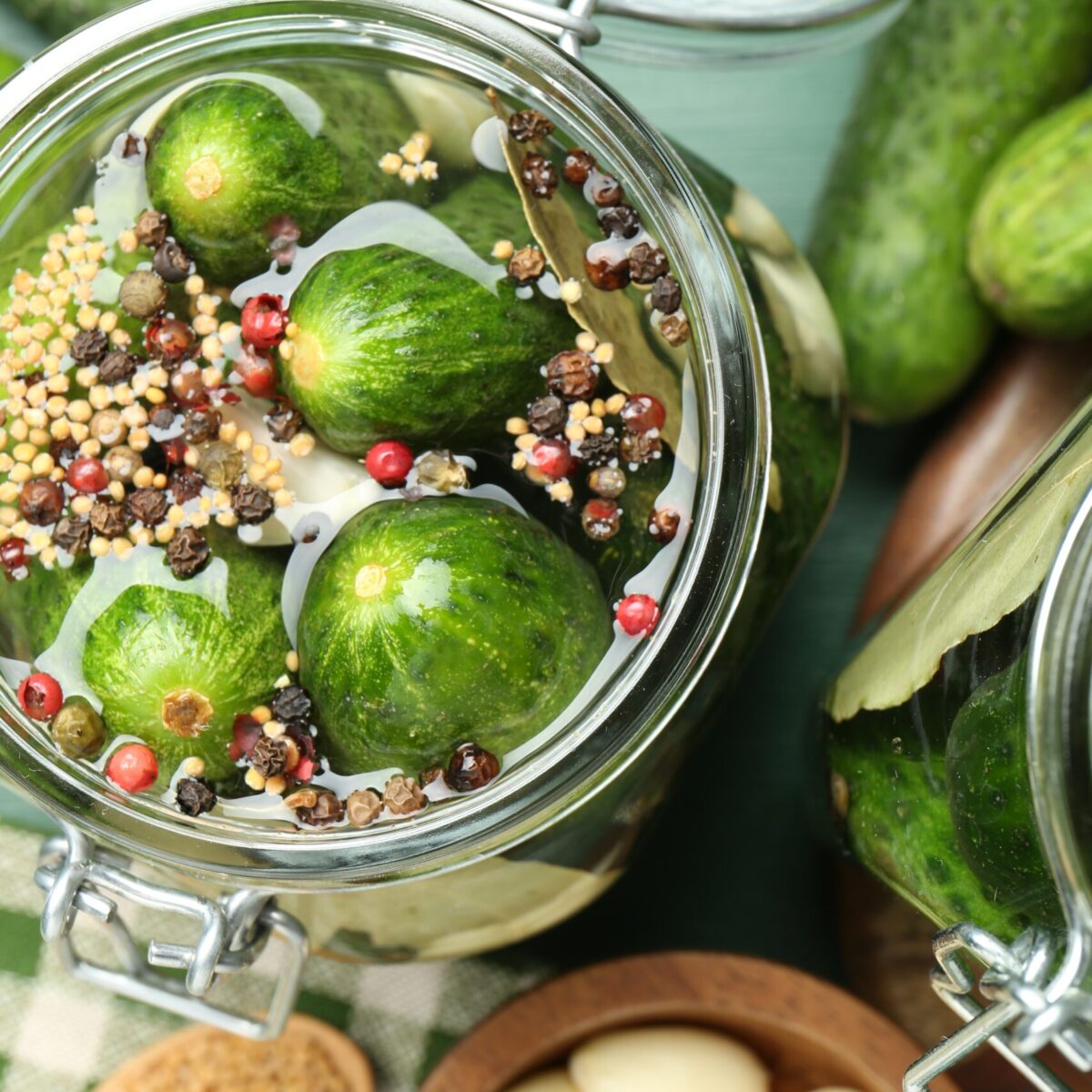 Making pickles. Fresh cucumbers and spices in jar on table, flat lay Making pickles. Fresh cucumbers and spices in jar on table, flat lay