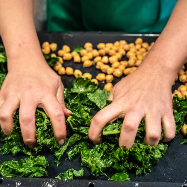 Chef preparing a dish of kale and chickpeas.
